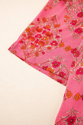 Close-up of the Morning Glory Blouse, showcasing its vibrant floral geometric pattern on pink fabric.