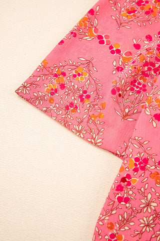 Close-up of the Morning Glory Blouse, showing its vibrant floral geometric pattern on pink fabric.