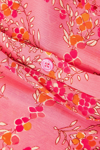 Close-up of the Morning Glory Blouse, showing its vibrant floral geometric pattern in pinks and oranges.