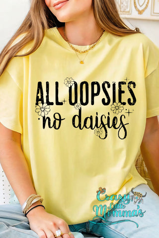 A woman wears a yellow "ALL OOPSIES no daisies" tee with small daisy graphics.