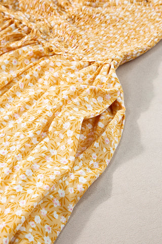 Close-up of the yellow floral maxi dress showing the smocked bodice and a side pocket.