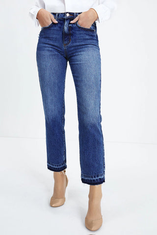 A person wearing Open Sky Bootcut Jeans with a distressed hem, paired with nude heels.