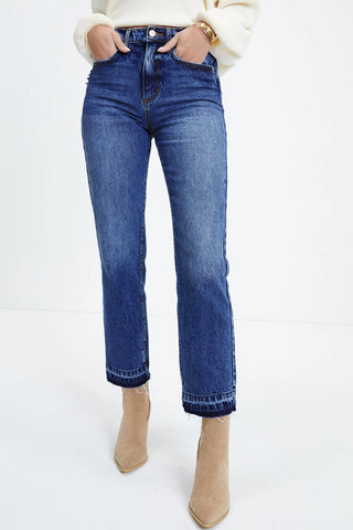 Open Sky Bootcut Jeans with a distressed hem, worn by a model with hands in pockets.
