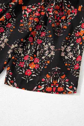Close-up of the Porchlight Bloom Button Top, a black floral lattice blouse with red and orange flowers.