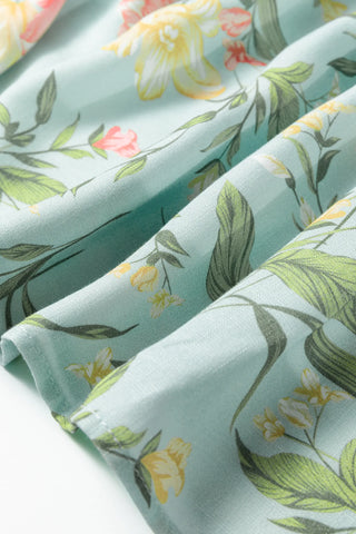 Close-up of the Prairie Bloom Smocked Dress fabric, showing a light blue background with yellow and pink floral print.