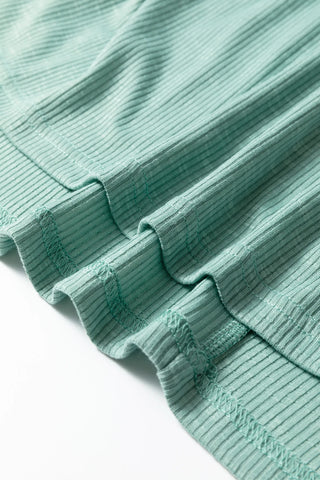 Close-up of the ribbed texture and stitching on the Prairie Camo Dreams Top, a soft camo sage tee.