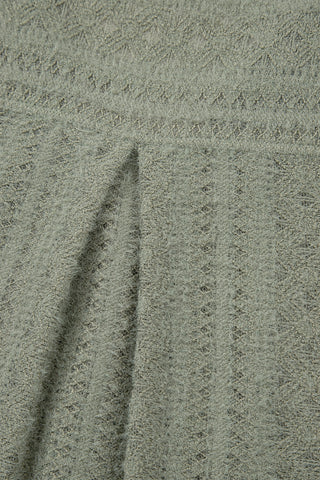 Close-up of the sage ruffle button top fabric, showing its textured, fuzzy knit and subtle vertical pattern.