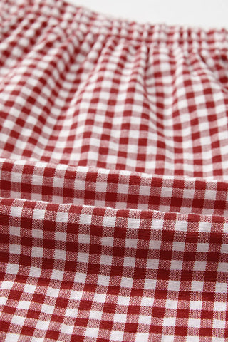 Close-up of Ranch Gingham Shorts, showing the red and white checkered pattern and gathered elastic waistband.
