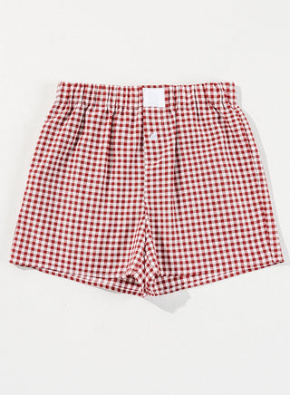Red and white gingham shorts with an elastic waistband and a single white button closure.