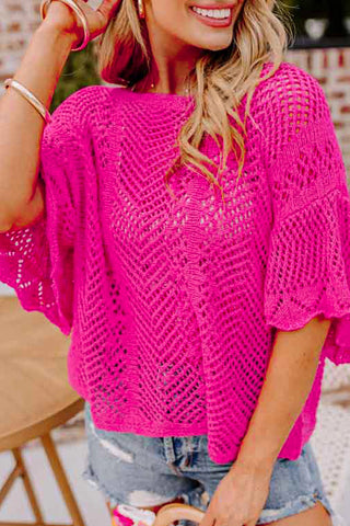 Woman wearing a bright pink Boho Chevron Knit Top with a unique open-knit pattern and flared sleeves.