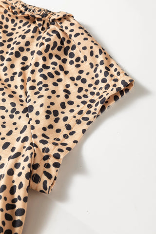 Close-up of the Untamed Beauty Top, showing the cheetah print fabric, ruffled neckline, and short sleeve.