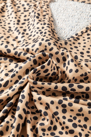 Close-up of the Untamed Beauty Top, a cheetah print ruffle blouse with black spots on a tan fabric.