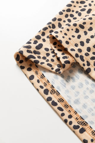 Close-up of the Untamed Beauty Top, showing the cheetah print fabric and detailed stitching.