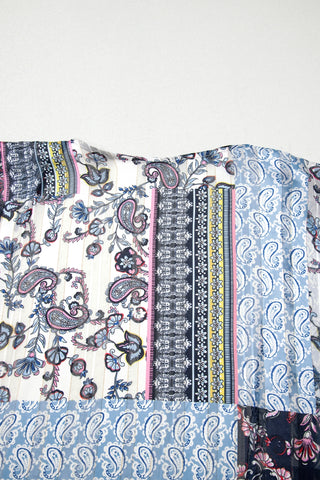 Close-up of the Wanderlust Patchwork Kimono, showcasing its diverse paisley and floral patterns in blue, pink, and white.