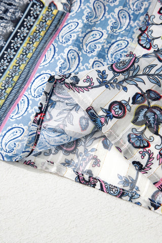 Close-up of the Wanderlust Patchwork Kimono, showing blue paisley and floral patterns with gold striped fabric.
