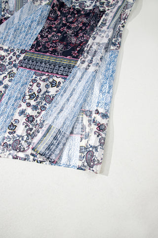 Close-up of the Wanderlust Patchwork Kimono, showcasing its intricate blue, white, and dark floral paisley patterns.