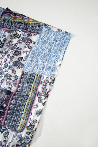 Close-up of the Wanderlust Patchwork Kimono, showcasing its intricate blue, pink, and white paisley and floral patterns.