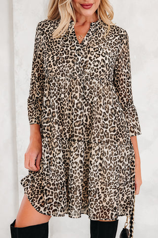 A woman models a Wild West Leopard Dress, a tiered country leopard dress with 3/4 sleeves and a v-neck.
