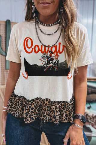 Wild Cowgirl Leopard Top with a graphic of a cowgirl on a horse and a Western leopard peplum hem.