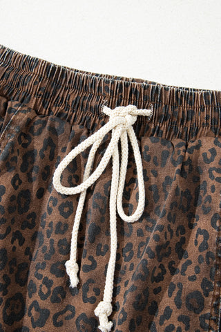 Close-up of a Wildcat Drawstring Skort, showing the brown leopard print fabric and white drawstring tied at the waist.