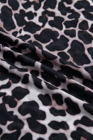Close-up of the Wildcat Mesh Mock Top, showing its black and white leopard print mesh fabric with subtle folds.