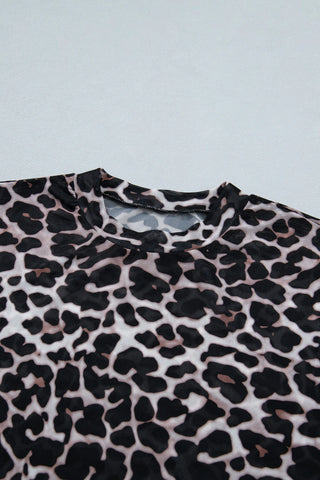Close-up of a Wildcat Mesh Mock Top, showcasing its leopard print mesh fabric and mock neck collar.
