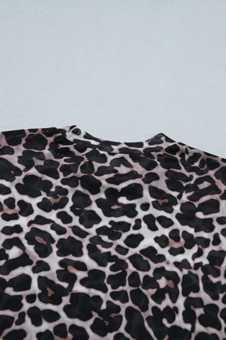 Close-up of a Wildcat Mesh Mock Top, showcasing its leopard print mesh fabric and mock neck.