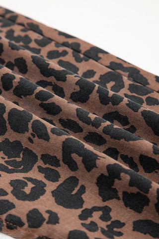 Close-up of a Wildcat Midi Denim Skirt, showing the brown fabric with black leopard print and subtle pleats.