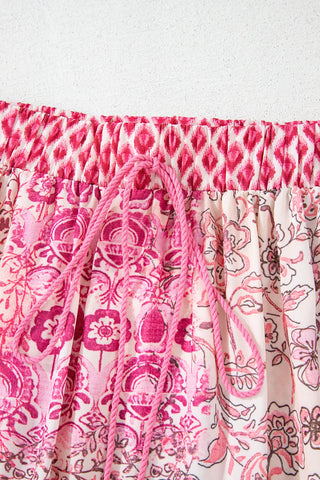 Close-up of a Wildflower Patchwork Maxi Skirt with a pink and white floral pattern and a pink drawstring.