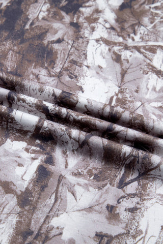 Close-up of the Wildwood Camo Tee fabric, showing its earthy camo pattern with brown and white tones.