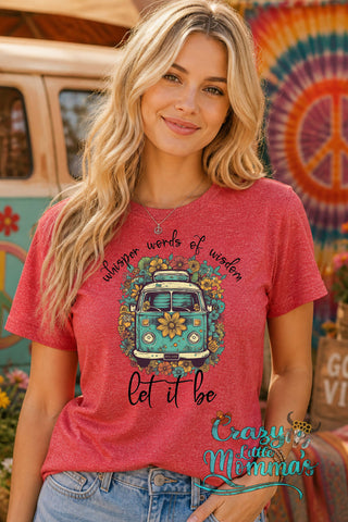 Woman in a red tee with a floral VW van graphic and "whisper words of wisdom let it be" text.