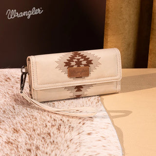 Beige Wrangler wallet with brown Aztec embroidery and wrist strap, on a cowhide rug.