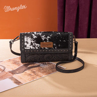 Wrangler black hair-on cowhide crossbody wallet with silver studs and embossed floral design.
