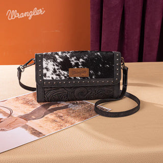 Black Wrangler hair-on cowhide crossbody wallet with studded trim and embossed floral design.