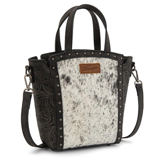 Black Wrangler tote/crossbody with genuine hair-on cowhide panel, floral tooling, and silver studs.