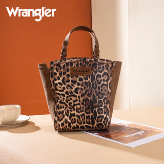 Wrangler leopard print tote/crossbody bag with brown suede sides and braided handles, on a table.