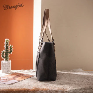Side view of the Wrangler Whipstitch Tote Bag in dark gray with light brown straps, on a faux fur rug.