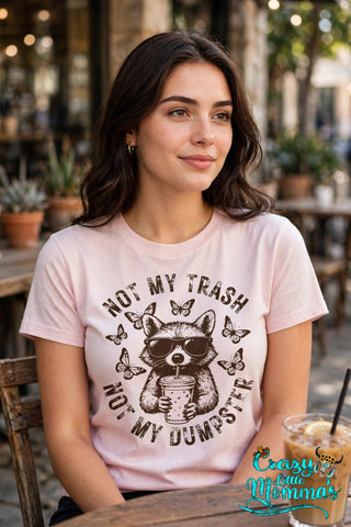 Dumpster Trash graphic tee on a light pink shirt