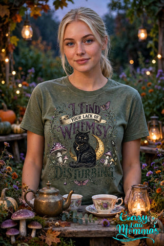 Whimsy is Disturbing graphic tee on a military green shirt